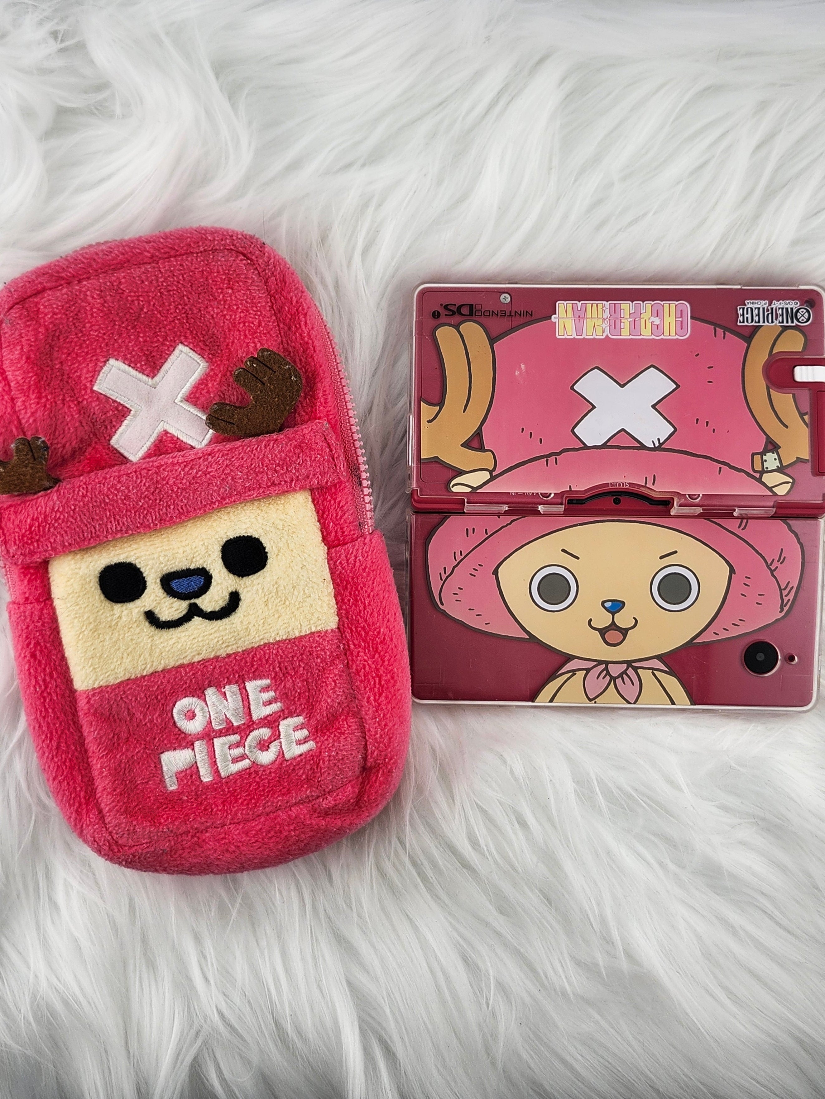 Pink phone case with cartoon character design on a white fluffy surface