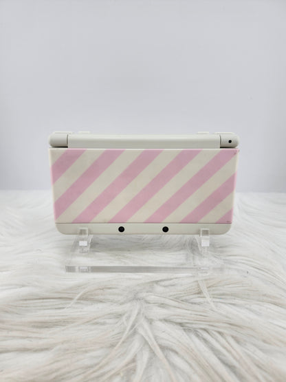 New 3ds con carcasas de rayas rosas y blancas